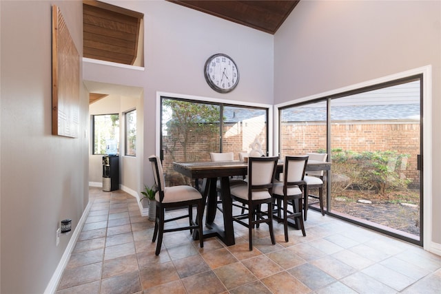 dining space featuring high vaulted ceiling and wooden ceiling