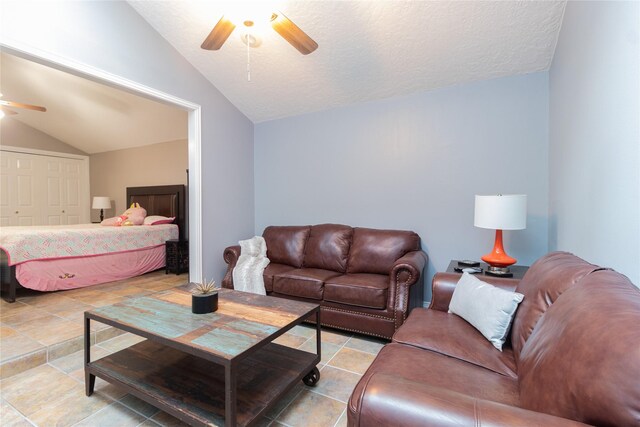 living room featuring ceiling fan, vaulted ceiling, and a textured ceiling