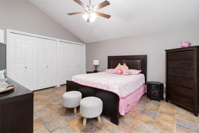 bedroom with two closets, vaulted ceiling, and ceiling fan