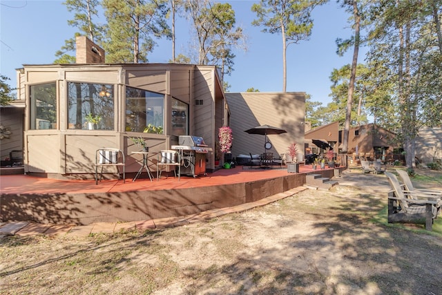 rear view of house featuring a sunroom