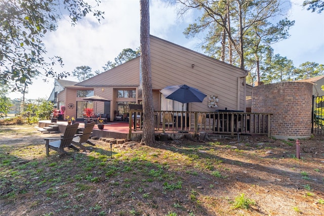 back of property featuring a wooden deck