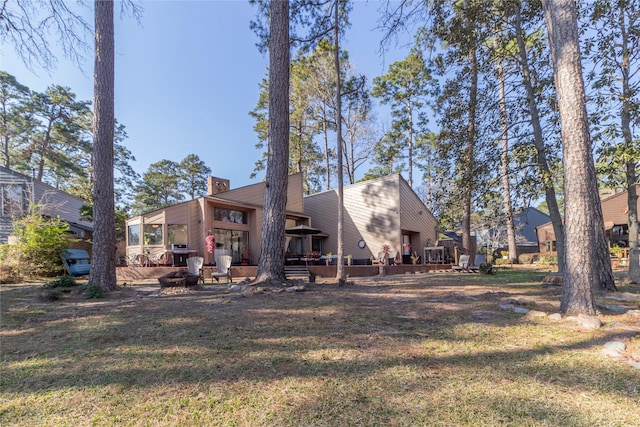 rear view of property with a lawn