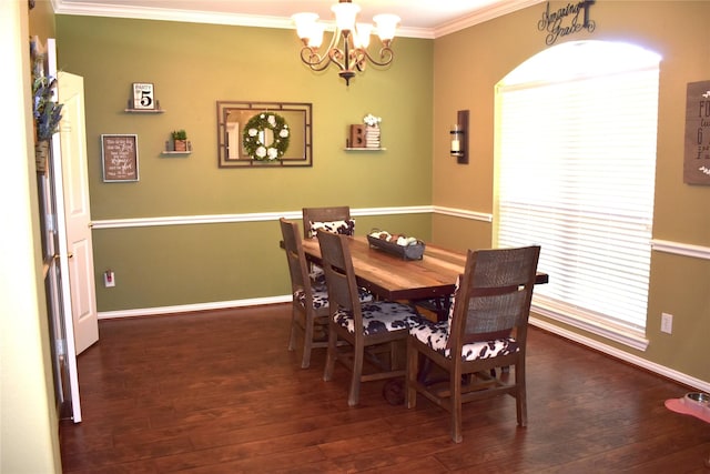 dining room with an inviting chandelier, ornamental molding, and dark hardwood / wood-style floors