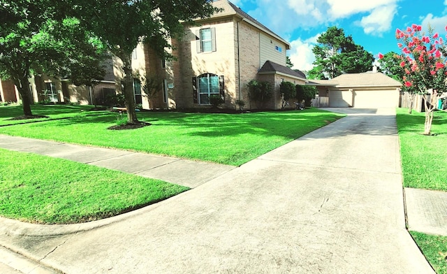 view of front of property featuring a garage and a front lawn