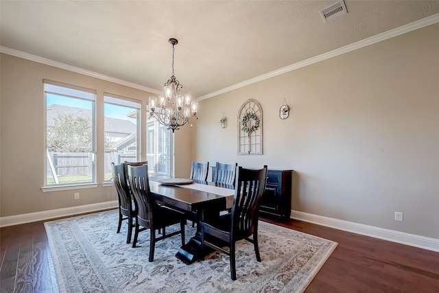 dining area with ornamental molding, dark hardwood / wood-style floors, and a notable chandelier