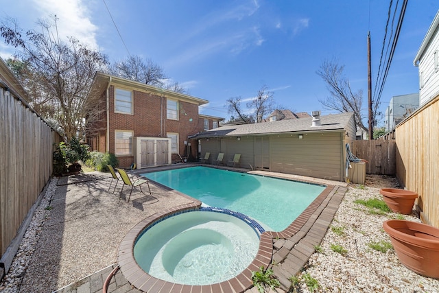 view of swimming pool featuring an in ground hot tub