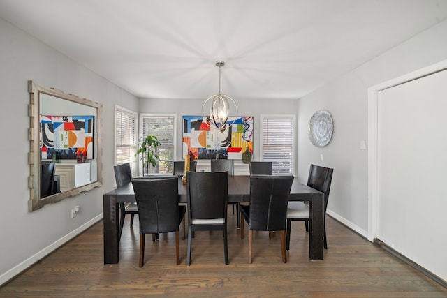 dining area featuring a notable chandelier and dark hardwood / wood-style flooring