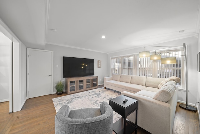 living room with crown molding and hardwood / wood-style floors