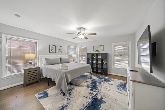 bedroom with wood-type flooring and ceiling fan