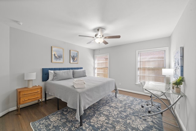 bedroom with dark hardwood / wood-style flooring and ceiling fan