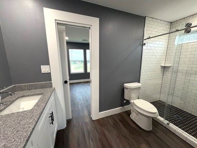 5053 E Fm 485, Cameron, TX 76520 - bathroom with vanity, hardwood / wood-style floors, toilet, and walk in shower