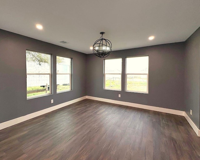 5053 E Fm 485, Cameron, TX 76520 - empty room featuring a notable chandelier and dark hardwood / wood-style floors