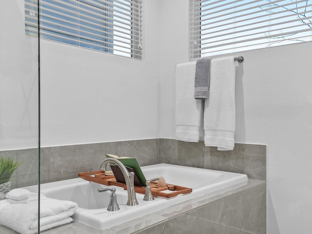 bathroom featuring tiled tub