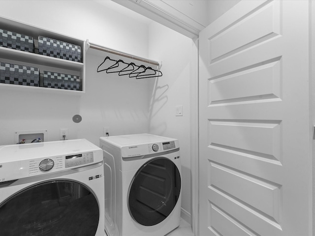 clothes washing area with washer and dryer