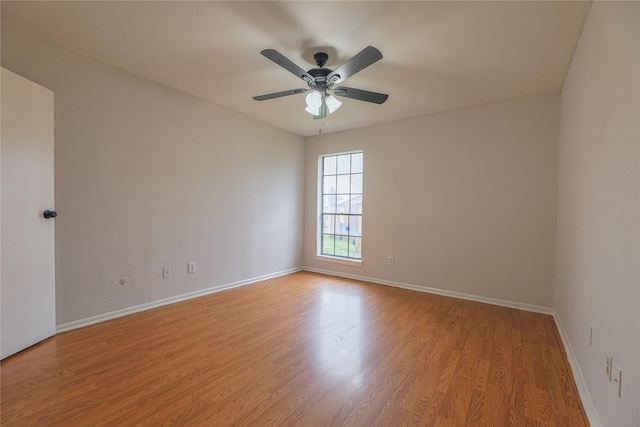 empty room with ceiling fan and light wood-type flooring