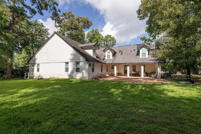 rear view of house with a yard and a patio