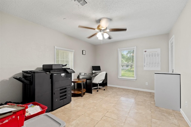 office with a textured ceiling and ceiling fan