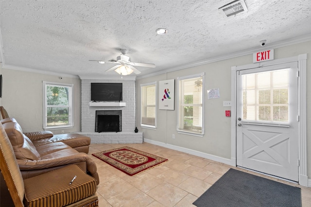 tiled living room featuring crown molding, plenty of natural light, and a fireplace