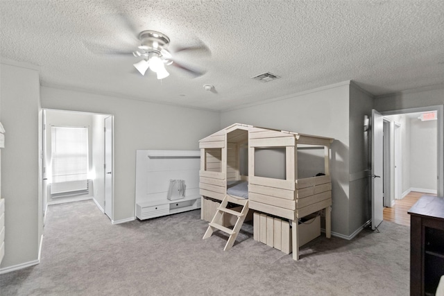 bedroom featuring ceiling fan, carpet floors, and a textured ceiling