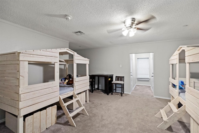 bedroom featuring ornamental molding, a textured ceiling, and carpet