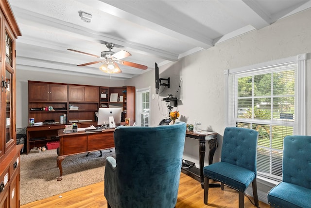 office featuring beamed ceiling, ceiling fan, and light wood-type flooring