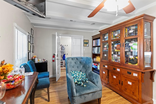 sitting room featuring beamed ceiling and light hardwood / wood-style floors