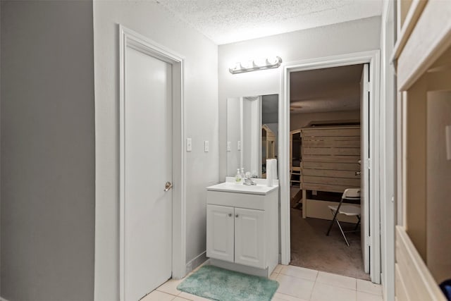 bathroom with vanity, tile patterned floors, and a textured ceiling