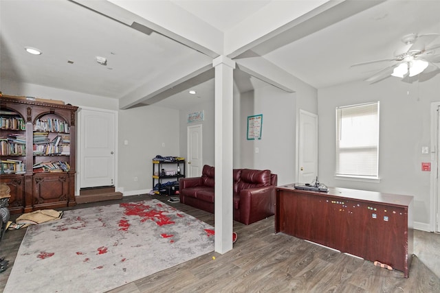 living room with hardwood / wood-style flooring, ceiling fan, and beamed ceiling