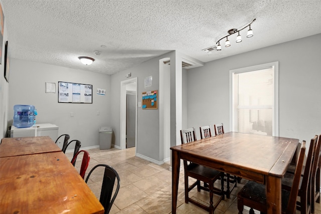 dining area featuring a textured ceiling