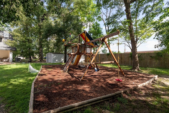 view of play area featuring a yard and a shed