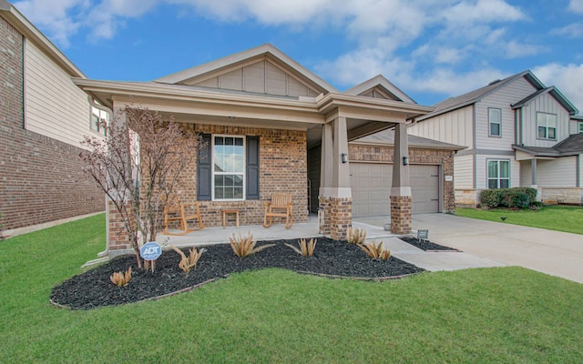 view of front of home with a garage, covered porch, and a front yard