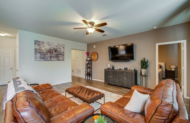 living room featuring ceiling fan and light wood-type flooring