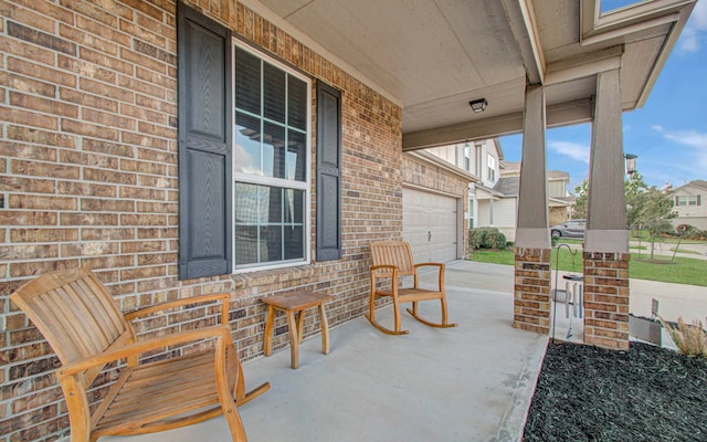 view of patio featuring a porch and a garage