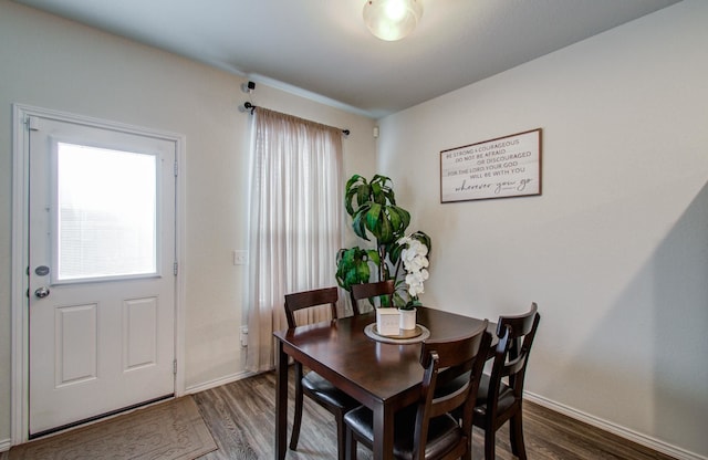 dining space with dark hardwood / wood-style floors