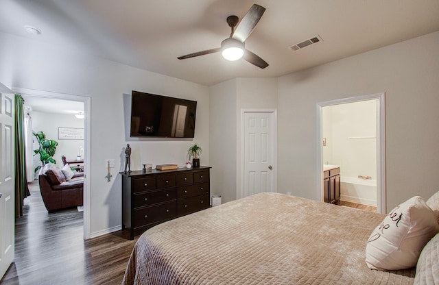 bedroom with ensuite bathroom, dark hardwood / wood-style floors, and ceiling fan