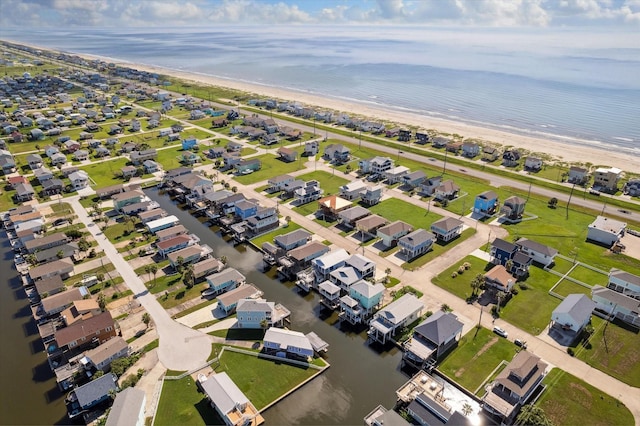 birds eye view of property featuring a beach view and a water view