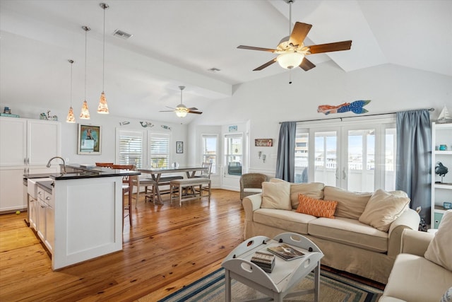 living room featuring french doors, ceiling fan, lofted ceiling, and light hardwood / wood-style floors