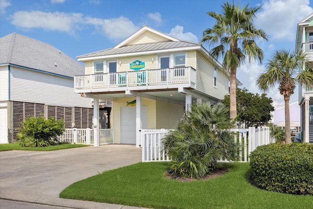 view of front of house with a garage, a front lawn, and a balcony