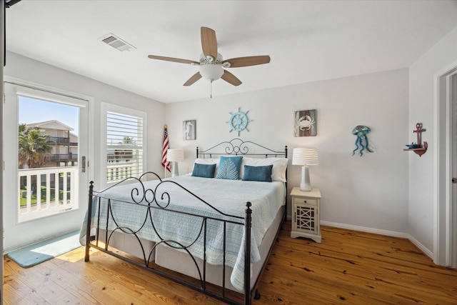 bedroom featuring ceiling fan, access to exterior, and hardwood / wood-style floors