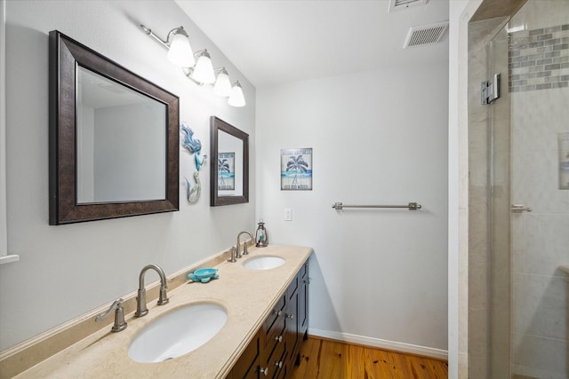 bathroom featuring vanity, an enclosed shower, and hardwood / wood-style floors