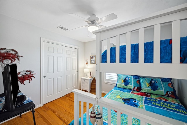 bedroom featuring hardwood / wood-style floors, a closet, and ceiling fan