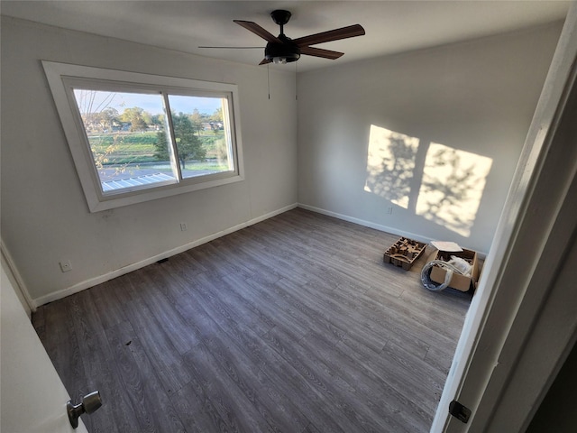 spare room featuring dark hardwood / wood-style floors and ceiling fan