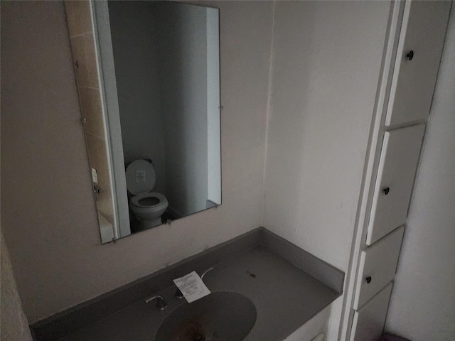 bathroom featuring sink and toilet