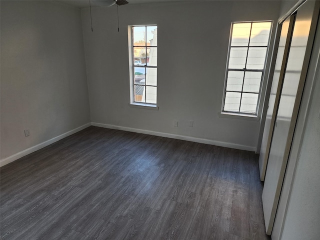 spare room with dark hardwood / wood-style flooring