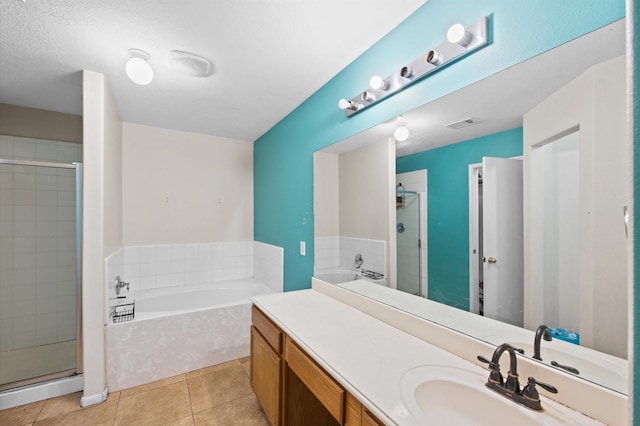 bathroom with tile patterned flooring, vanity, and independent shower and bath