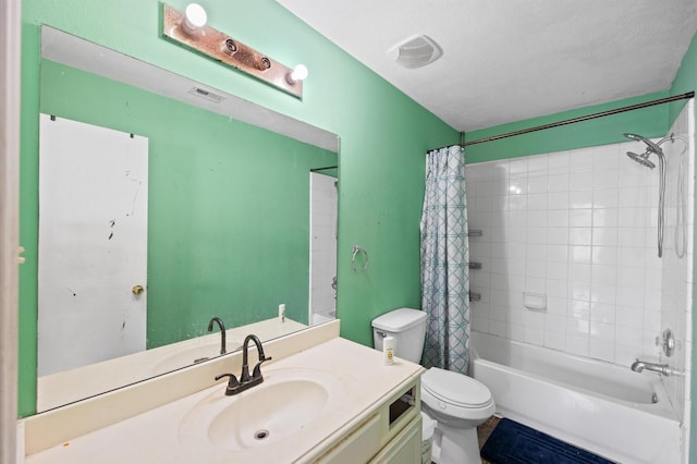 full bathroom with vanity, a textured ceiling, toilet, and shower / bath combo