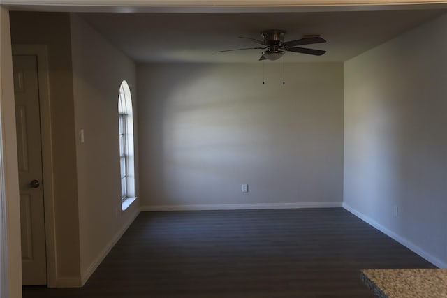 empty room featuring ceiling fan and dark hardwood / wood-style flooring