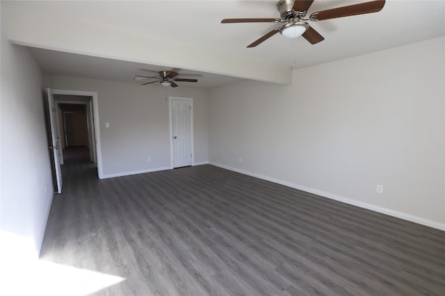 spare room featuring ceiling fan, dark hardwood / wood-style floors, and beam ceiling