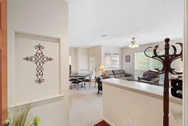 carpeted living room featuring ceiling fan