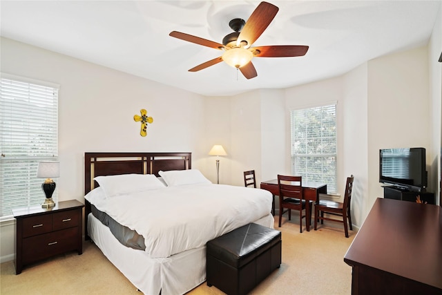 bedroom featuring light carpet and ceiling fan